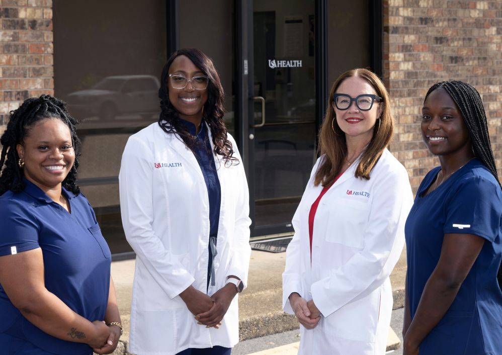 Providers stand outside USA Health Adolescent and Young Adult Health