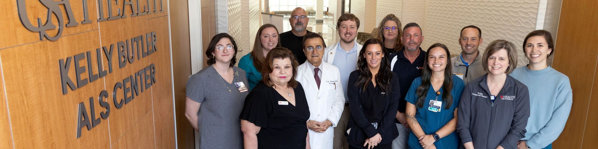 The staff of the Kelly Butler ALS Center stands outside its entrance.