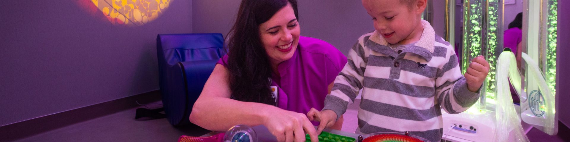 A nurse and a child play together in the sensory room at the Pediatric Emergency Center.