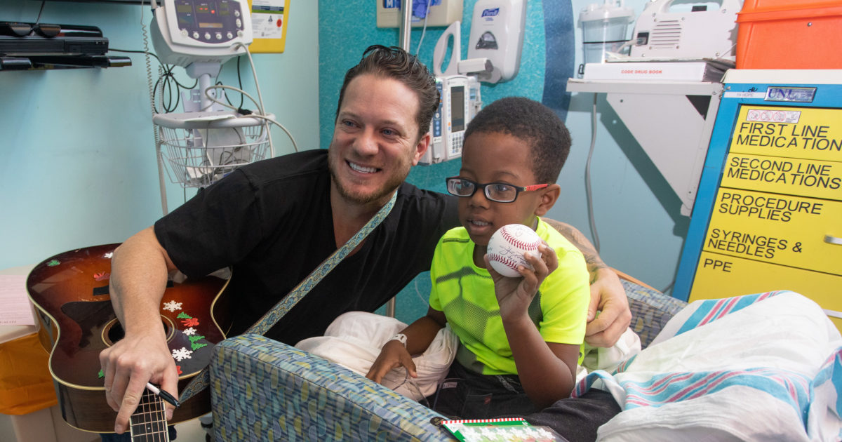 Young patients entertained by baseball all-star Jake Peavy at holiday party