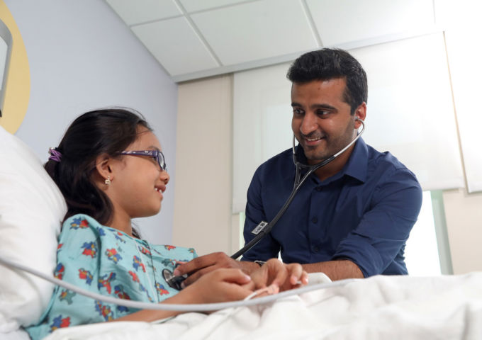 Mukul Sehgal, M.D., with a pediatric patient